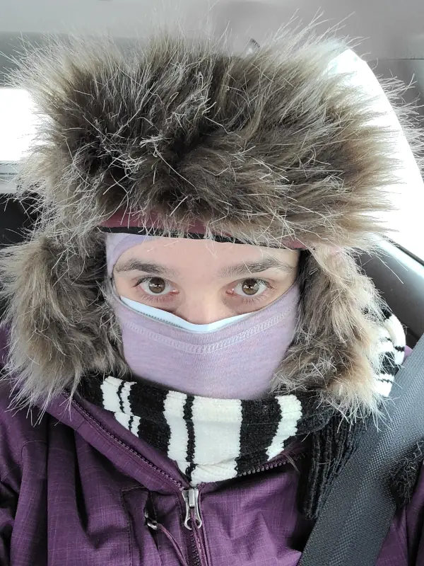 A very bundled up Veronica Cary wearing a big fuzzy hat and lots of layers- you can only see my eyes.