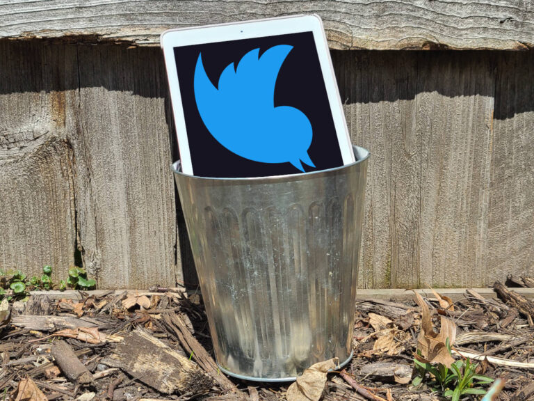 A tablet in a small trashcan. The Twitter logo is prominent on the tablet.