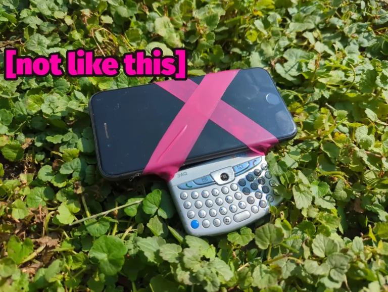 It's a smartphone taped to an older BlackBerry-style phone. The phones are sitting in a field of clover and superimposed are the words "[not like this]".