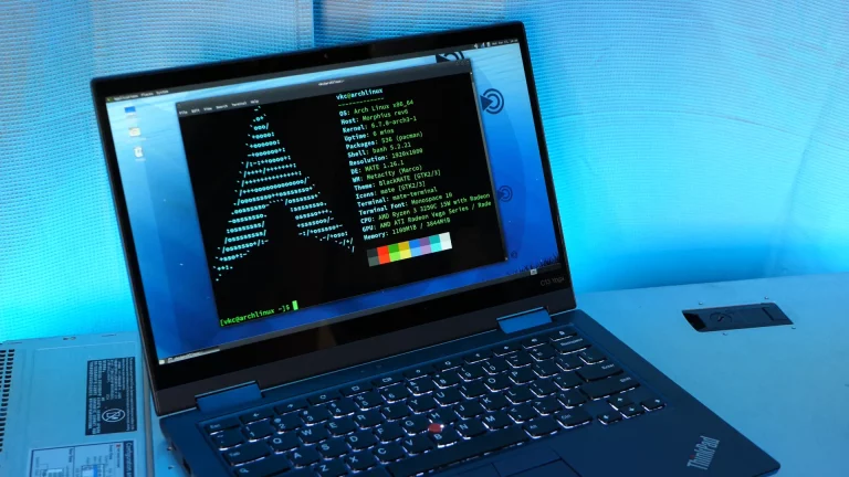 A small laptop showing an Arch Linux neofetch screen.